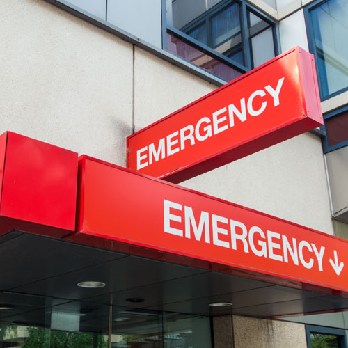 Red emergency signs at the entrance of a hospital building