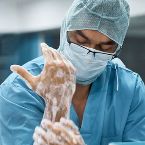 Surgeon scrubbing hands before surgery – strict infection control and hygiene protocol in hospital setting