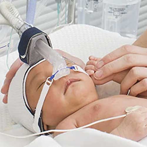 A digital illustration of a fetus inside a womb, with three medical instruments gently accessing the amniotic fluid.